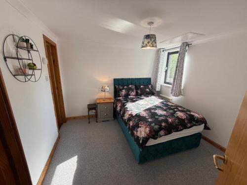 a small bedroom with a bed and a window at Ferryhills Riverside Retreat in Aberdeen