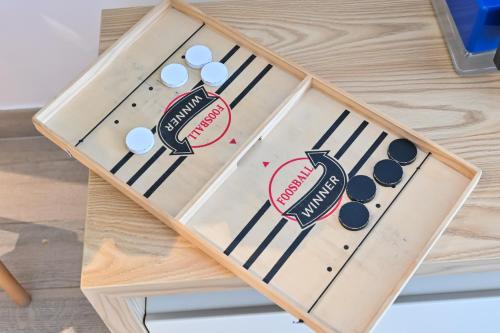 a wooden box with a baseball game on it at Walk To Mall, Chic Decor 1br! Near Ferrari, F1 in Abu Dhabi