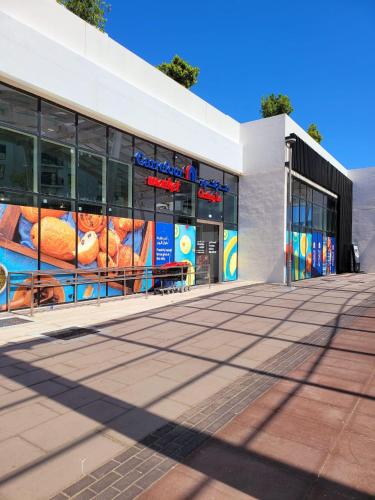 a fast food restaurant withspectacular signs on the facade at Walk To Mall, Chic Decor 1br! Near Ferrari, F1 in Abu Dhabi
