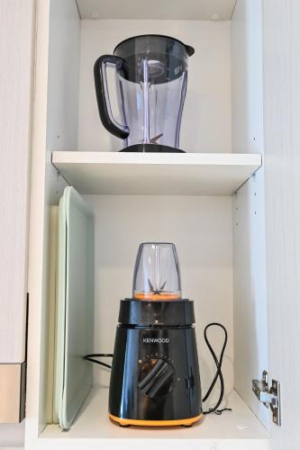 a blender sitting on a shelf in a refrigerator at Walk To Mall, Chic Decor 1br! Near Ferrari, F1 in Abu Dhabi