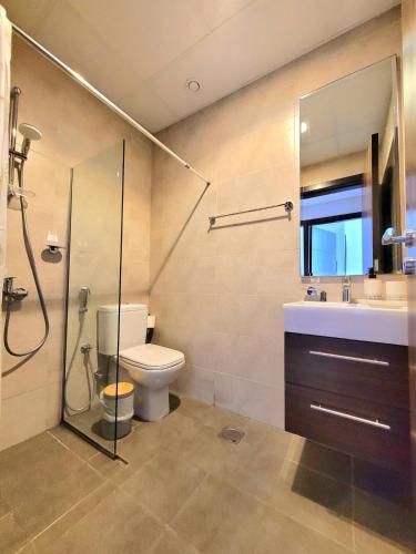 a bathroom with a toilet and a sink and a shower at Damac Hills 2 Villa Pool Front + Waterpark Access in ‘Ūd al Bayḑāʼ