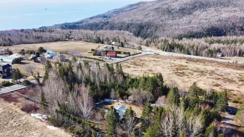an aerial view of a village in the mountains at La Petite Ourse - boisé avec spa in Petite-Rivière-Saint-François