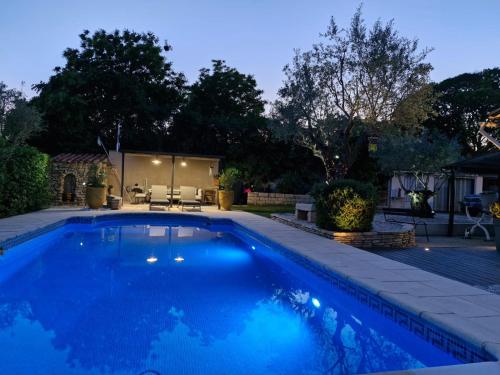 une piscine dans un jardin la nuit dans l'établissement Les Mésanges, à Castelnau-le-Lez