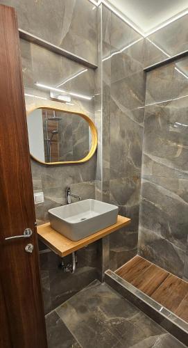 a bathroom with a sink and a mirror at Black and white suites 2 in Thessaloniki