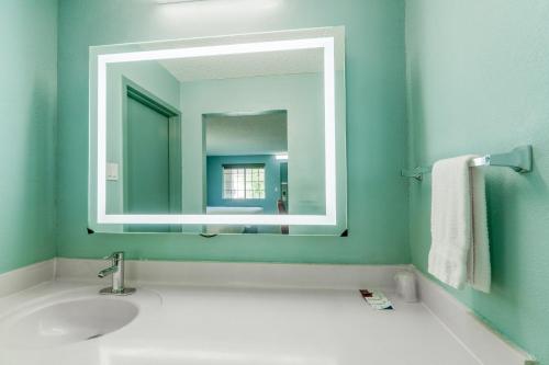 a bathroom with a sink and a mirror at Lone Star Inn & Suites by OYO Harlingen TX in Harlingen