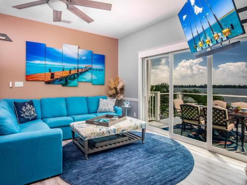 a living room with a blue couch and a view of the ocean at Into the Blues in Bay Point