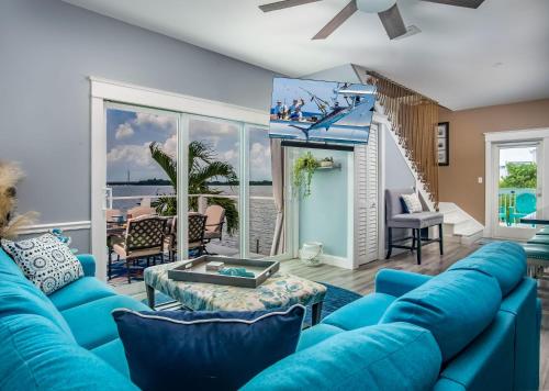 a living room with blue furniture and a view of the ocean at Into the Blues in Bay Point