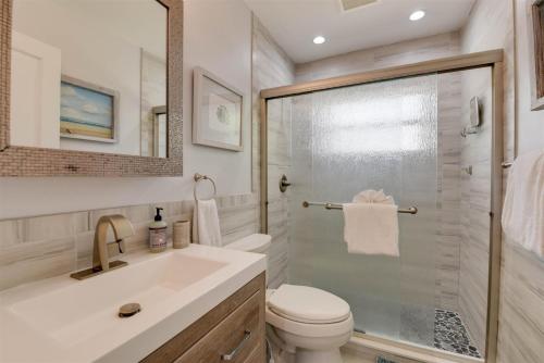 a bathroom with a toilet and a sink and a shower at Casa de Sueno in Summerland Key
