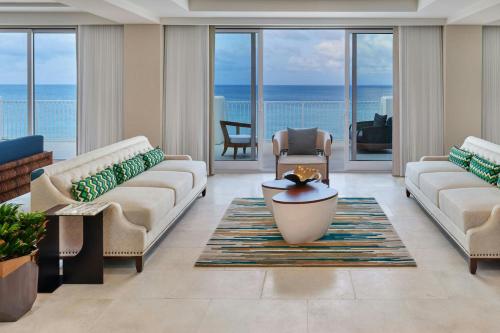 a living room with two couches and a table at The St. Regis Bermuda Resort in Saint George