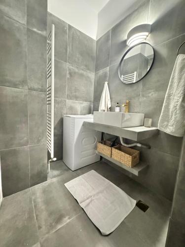 a bathroom with a sink and a mirror at Beachfront ! in Amarynthos