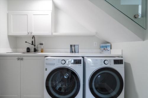 a white laundry room with a washer and dryer at Yeya's Hideaway in Big Pine Key