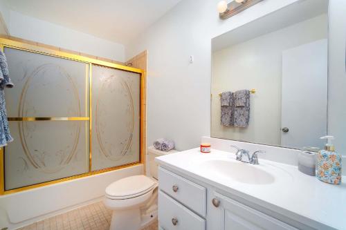 a bathroom with a toilet and a sink and a shower at Our Happy Place in Sugarloaf Shores