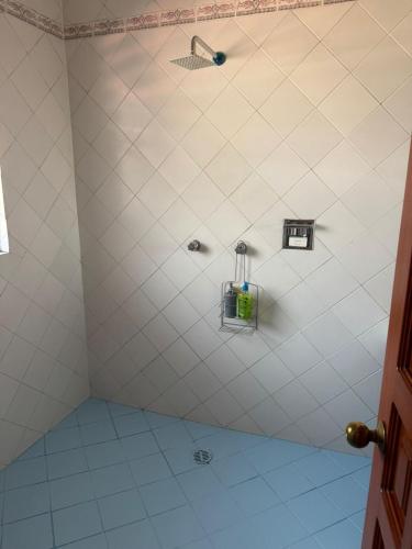 a bathroom with a shower with a bottle in it at Casa Refugio Budget House 8 Rooms & 9 Bathrooms in Oaxaca City