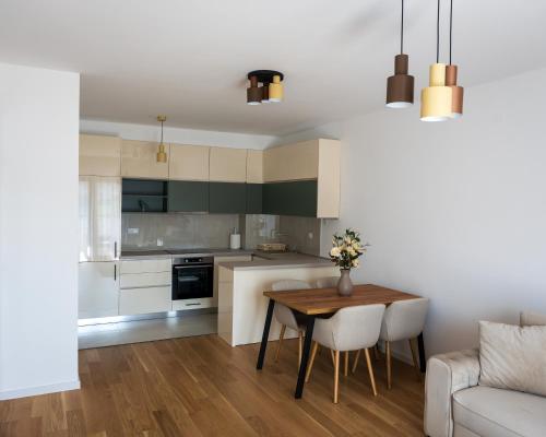 a small kitchen with a table and a couch at Apartman Sara Trebinje in Trebinje