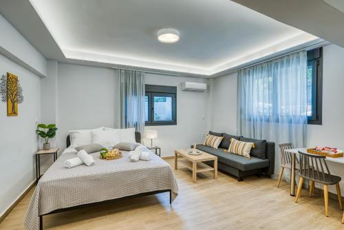 a bedroom with a bed and a couch and a table at Virginia Haven 2 in Chios