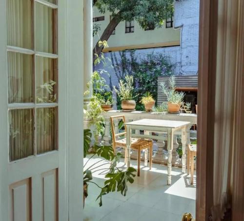 a table and chairs on a patio with plants at Casa Moctezuma in Mexico City