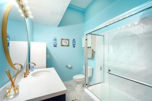 a bathroom with a shower and a sink and a toilet at Key Lime Hideaway in Key West