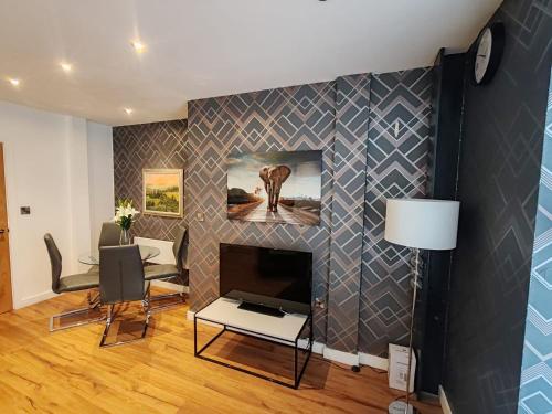 a living room with a fireplace with a painting of an elephant at The Cosy Quarters - Popworks in Manchester