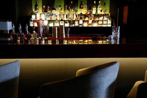 a bar with a lot of bottles of alcohol at Wyndham Monterrey Ambassador Centro in Monterrey
