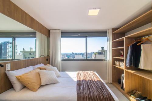 Katil atau katil-katil dalam bilik di Tempo The Arch - Bela Vista, Auxiliadora, Apartamentos em Porto Alegre