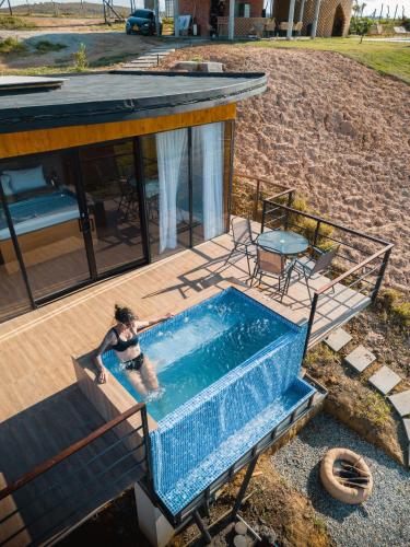 a woman in a swimming pool in a house at Oasis Barichara in Barichara