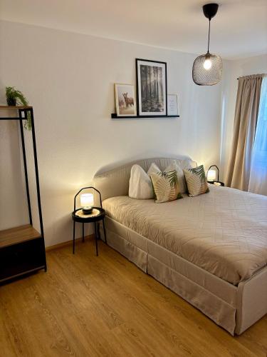 a bedroom with a bed with two lamps on it at Visit Oberhof 2 in Oberhof
