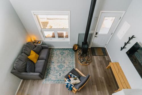 an overhead view of a living room with a couch and a window at Abraham - Peaceful Tiny Cabin In Historic Nordegg in Nordegg