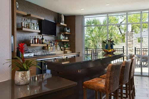 a bar with a counter and chairs in a room at SpringHill Suites by Marriott Austin Cedar Park in Cedar Park