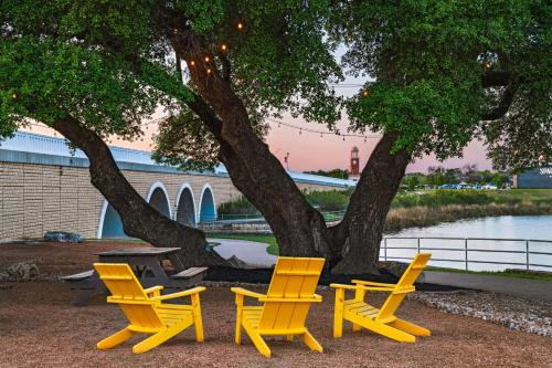 a group of yellow chairs and a table under a tree at SpringHill Suites by Marriott Austin Cedar Park in Cedar Park