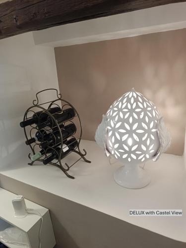 a lamp and a vase sitting on a shelf at Dimora Arco Basso - Old Town in Bari