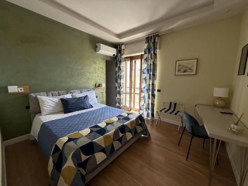 a bedroom with a bed and a table and a desk at Frida in San Giorgio a Cremano