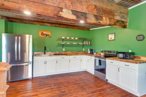 a kitchen with white cabinets and green walls at Near Wineries Country Condo in New Haven in New Haven