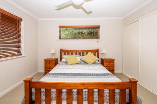 a bedroom with a bed and a ceiling fan at Bel Mare - Family Fun in Apollo Bay