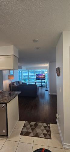 a kitchen and living room with a couch in a room at Lovely condo near Lake Ontario in Toronto