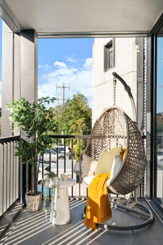 a porch with a swinging chair on a balcony at Sunny Richmond Escape 2BR and Large Balcony in Melbourne