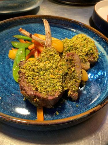 a blue plate of food with meat and vegetables at The Retreat Hotel in Strathpeffer