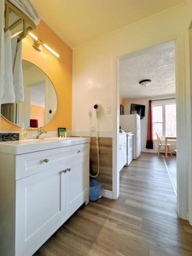 a bathroom with a white sink and a mirror at Fair Isle Motel in Charlottetown