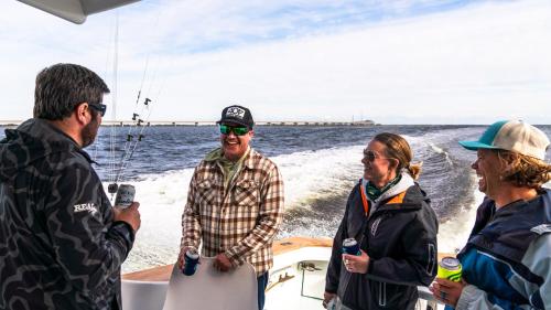 a group of people on a boat in the water at S-Turns - 3-Bedroom, 3-Bathroom Suite at REAL Watersports in Waves