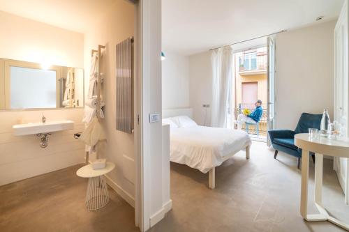 a hotel room with a bed and a sink at Shalai - Exclusive SPA and small gourmet hotel in Linguaglossa