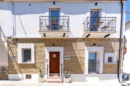 a building with two balconies and a door at Dimora 59 in Santa Maria Imbaro