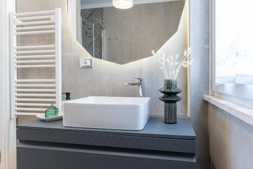 a bathroom with a white sink and a mirror at Dimora 59 in Santa Maria Imbaro