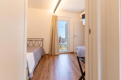 a bedroom with a bed and a window with a balcony at Dimora 59 in Santa Maria Imbaro