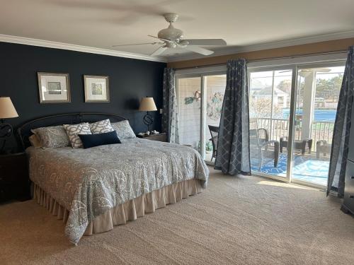 a bedroom with a bed and a ceiling fan at Luxurious Bayville Shores Home Close to the Beach! in Selbyville