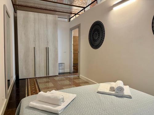 a bedroom with two towels sitting on a bed at Casa San Pietro - Scicli in Scicli