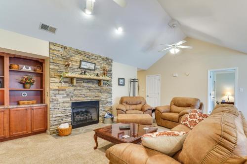 a living room with a couch and a fireplace at Home 2 Mi to Island in Pigeon Forge! in Pigeon Forge