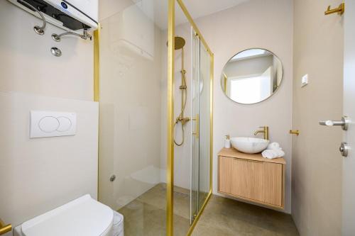 a bathroom with a shower and a toilet and a sink at Apartments Sunset Komarna in Komarna