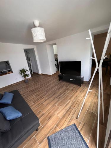 a living room with a couch and a flat screen tv at Los Abuelos Vivienda Vacacional in Valverde