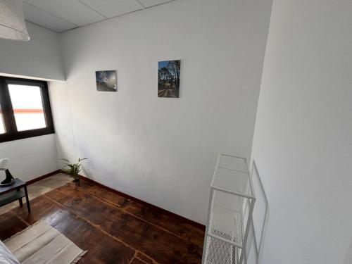 a room with a white wall and a stair case at Los Abuelos Vivienda Vacacional in Valverde