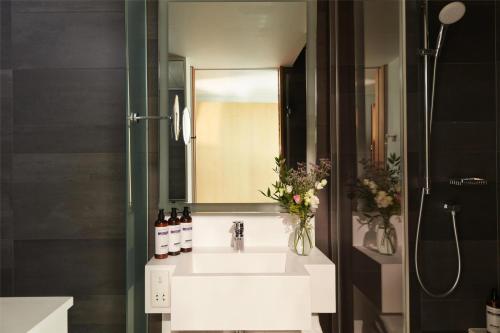 a bathroom with a sink and a mirror at Hyatt Regency Paris Etoile in Paris