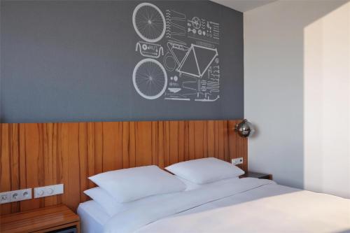 a bedroom with a bed with a chalkboard on the wall at Hyatt Regency Paris Etoile in Paris